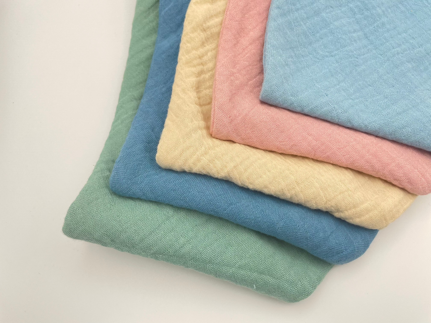 Sage, Whale Blue, Light Blue, Oat and Dusty Pink dribble bibs